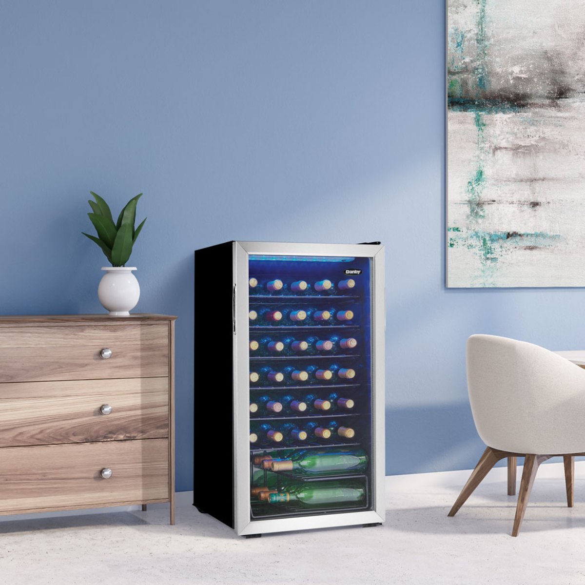Danby 36 Bottle Freestanding Wine Cooler in Stainless Steel - fridge beside a dresser in a modern living space