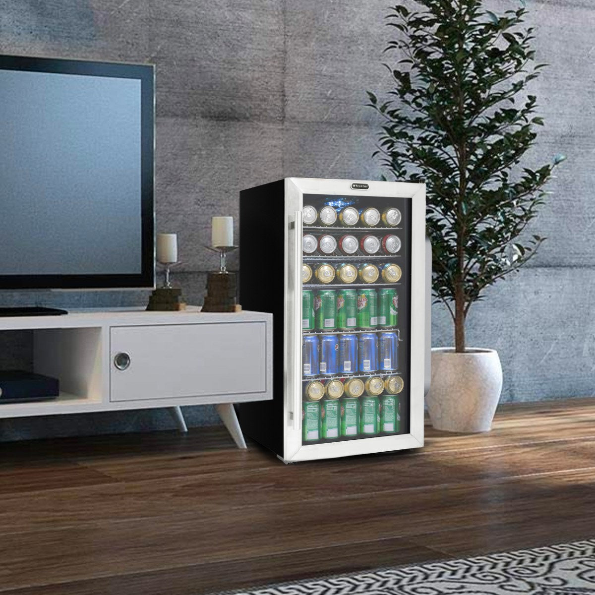 Whynter BR-130SB 127-Can Freestanding Beverage Refrigerator - stocked with assorted cans, placed beside a TV console in a modern living room