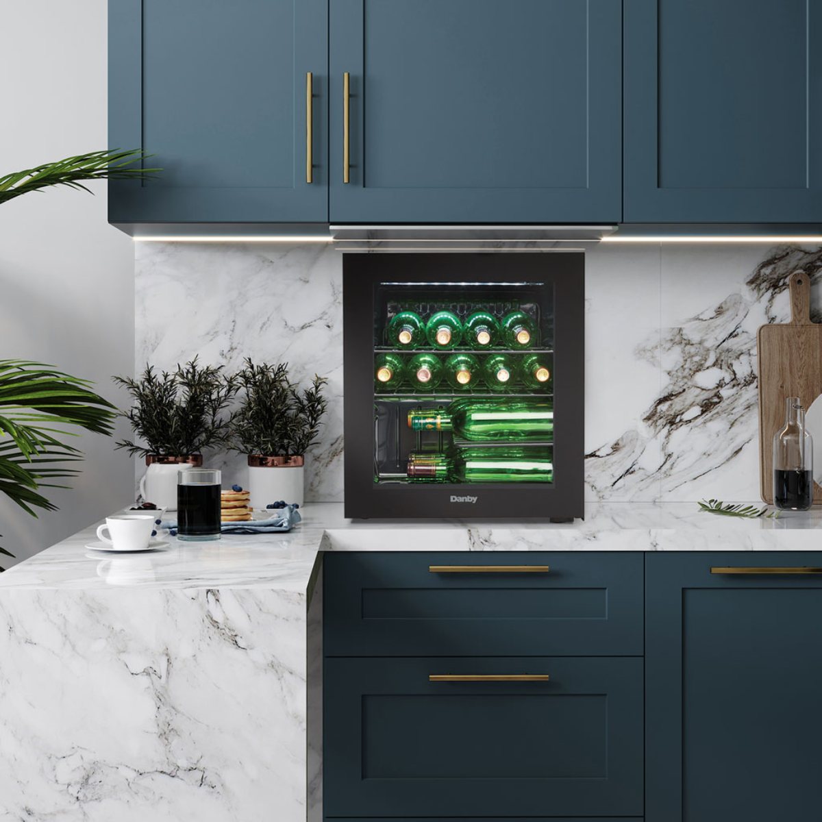 Danby 16 Bottle Freestanding Wine Cooler in Black - built into a marble countertop kitchen with navy cabinets