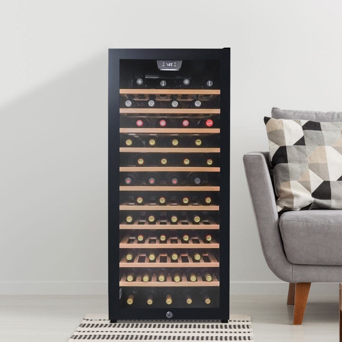 Danby 94 Bottle Freestanding Wine Cooler in Black - beside a grey sofa and patterned pillow