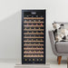 Danby 94 Bottle Freestanding Wine Cooler in Black - beside a grey sofa and patterned pillow