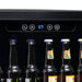 NewAir 24” Built-In 177-Can Beverage Fridge in Black Stainless Steel - Close up view of the digital thermostat with bottles of beer
