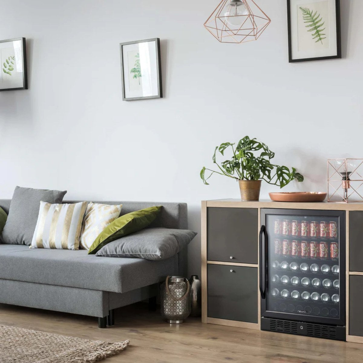 NewAir 24” Built-In 177-Can Beverage Fridge in Black Stainless Steel - fridge stocked with cans in a modern kitchen with black countertops