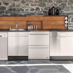Newair 24″ 80-Can / 20-Bottle Dual Drawer Beverage Fridge - Stainless steel drawer refrigerator built into a stone-accent kitchen