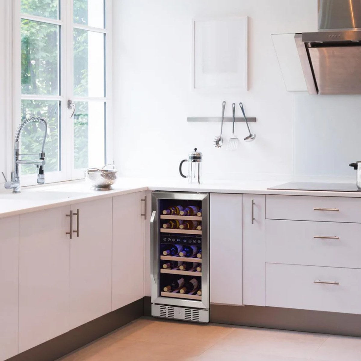 Newair 29 Bottle Dual Zone Wine Fridge – 14.8" Stainless Steel - Built-in wine cooler in a bright white kitchen with large window