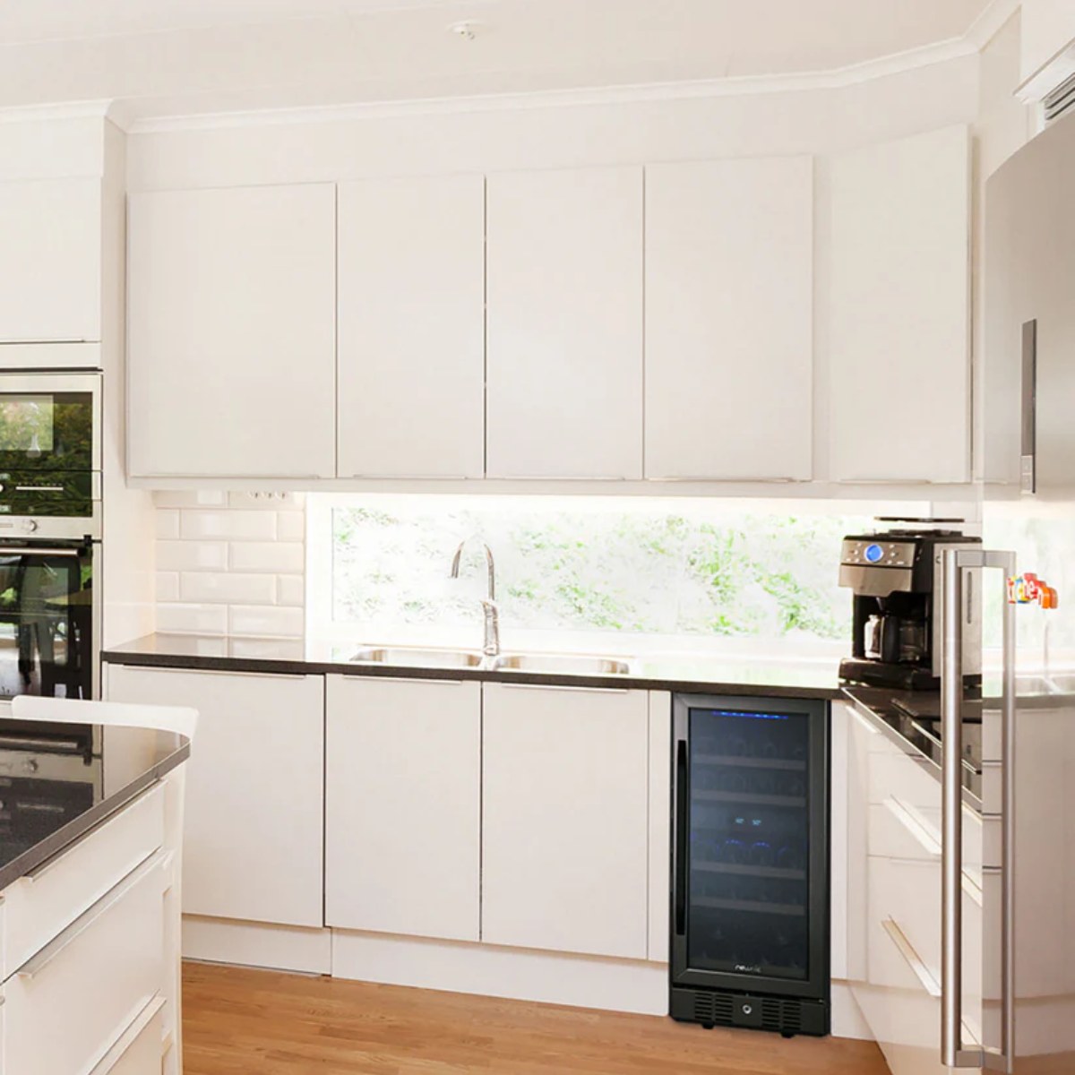 Newair 29 Bottle Dual Zone Wine Fridge – 15" Black Stainless Steel - fridge with the door open in a glossy white kitchen