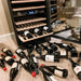 Newair 46 Bottle Dual Zone Wine Cooler – 23.5" Black Stainless Steel - Wine bottles scattered on the floor beside open fridge