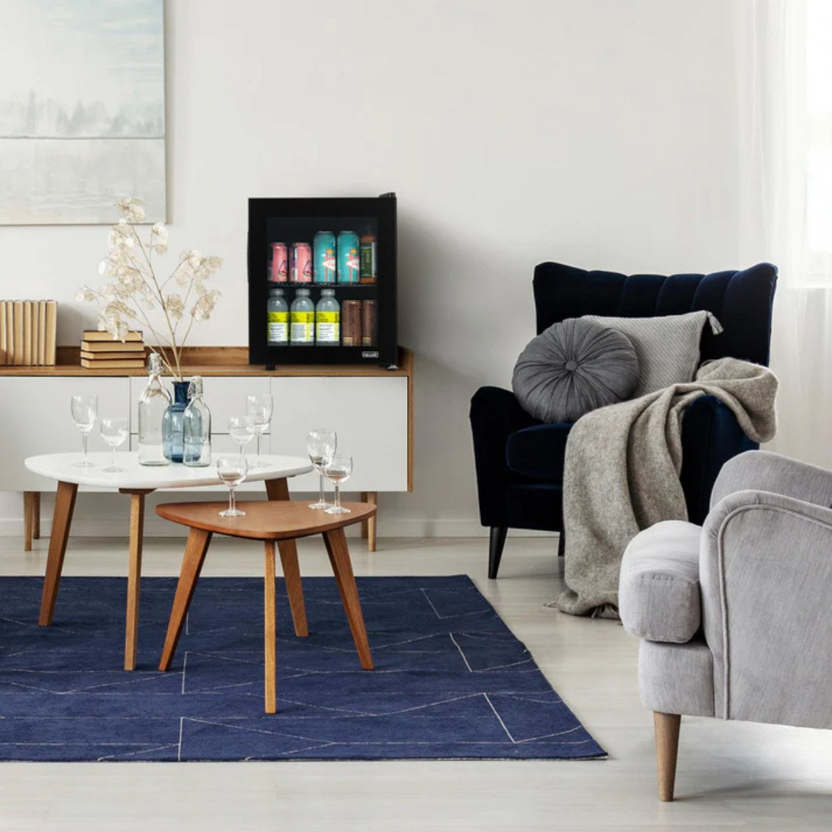 Newair 60-Can Freestanding Beverage Fridge – 16.75" Black - placed on a white sideboard in a cozy living room with modern furniture