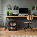Newair 60-Can Freestanding Beverage Fridge – 16.75" Black - placed under a wooden desk in a modern home office with plants, a computer, and a wooden chair