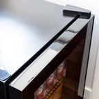 Newair 90-Can Freestanding Beverage Fridge – 17″ Black - close-up view of its top corner and door frame