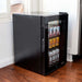 Newair 90-Can Freestanding Beverage Fridge – 17″ Black - fridge filled with canned drinks positioned next to a kitchen