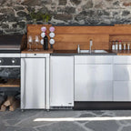 Newair 90-Can Outdoor Beverage Fridge – 15″ Built-In/Freestanding - Built-in stainless steel beverage fridge in an outdoor kitchen with stone and wood accents