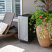 Newair 90-Can Outdoor Beverage Fridge – 15″ Built-In/Freestanding - beverage fridge beside a large planter and wicker lounge chair