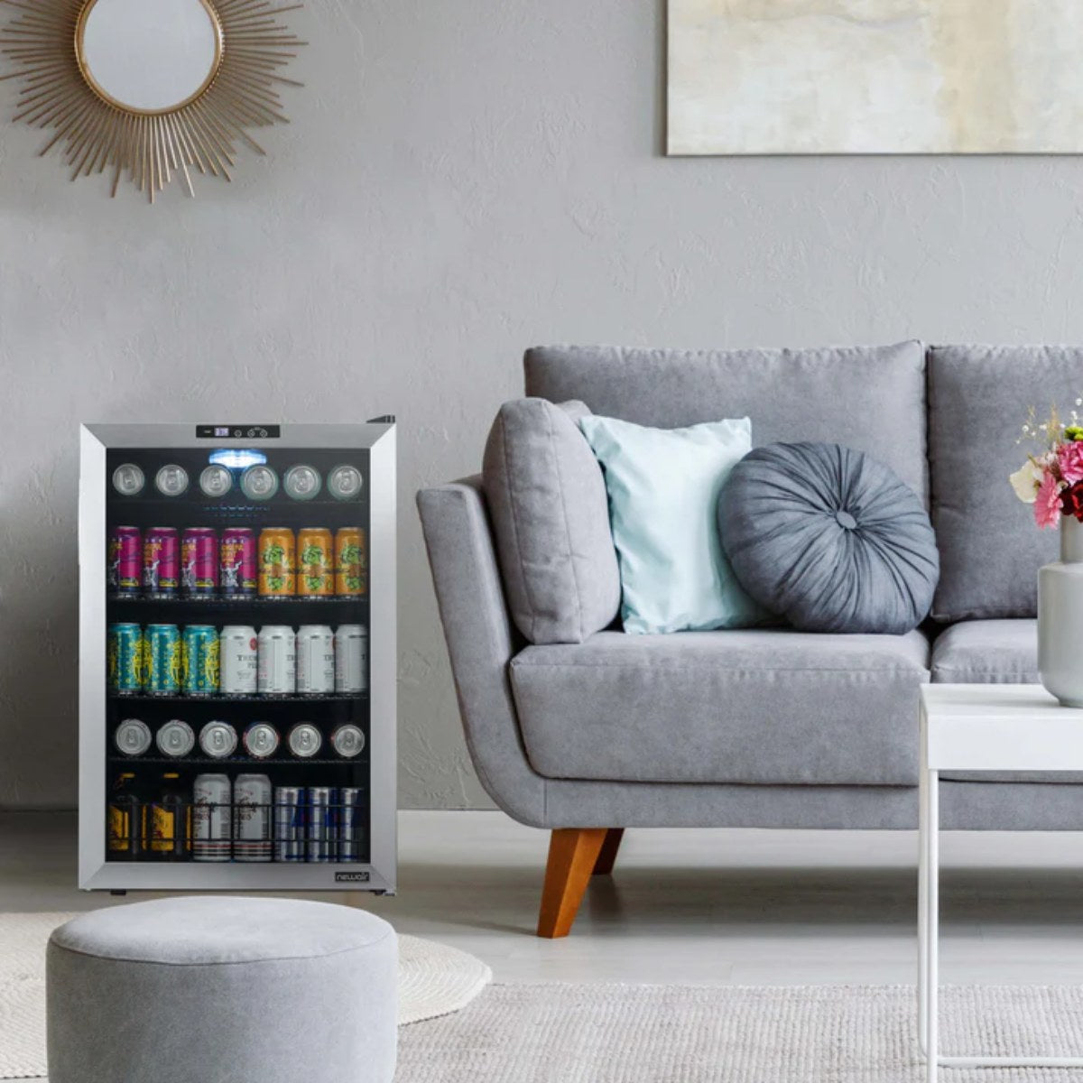 Newair SplitShelf 160-Can Freestanding Stainless Steel Beverage Fridge - Grey living room with a stainless beverage fridge next to the sofa