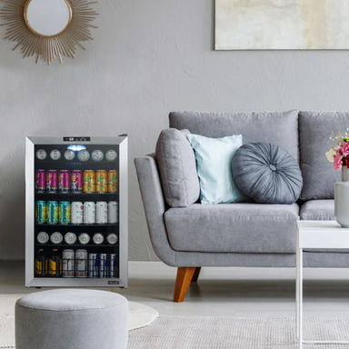 Newair SplitShelf 160-Can Freestanding Stainless Steel Beverage Fridge - Grey living room with a stainless beverage fridge next to the sofa