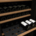 Transtherm by EuroCave Prestige 27" 74 Bottle Single Zone Wine Fridge - close up view of the steel shelves with wood front with wines