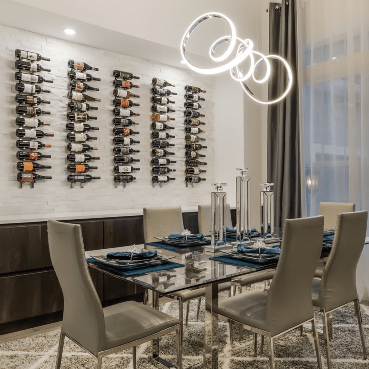 Ultra 1FT Label-Out Horizontal Wall Rail Wine Rack (3–9 Bottles) - Modern dining room with wall-mounted wine racks and a glass table under a sculptural light fixture