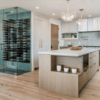 Ultra 4FT Cork-Out Straight Wall Rail Wine Rack (12 Bottles) - Modern kitchen with glass-enclosed wine cellar beside a large island and pendant lighting