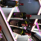 Ultra Cork-Out Straight Wine Peg - Close-up of wine bottles displayed on illuminated racks with purple LED lighting