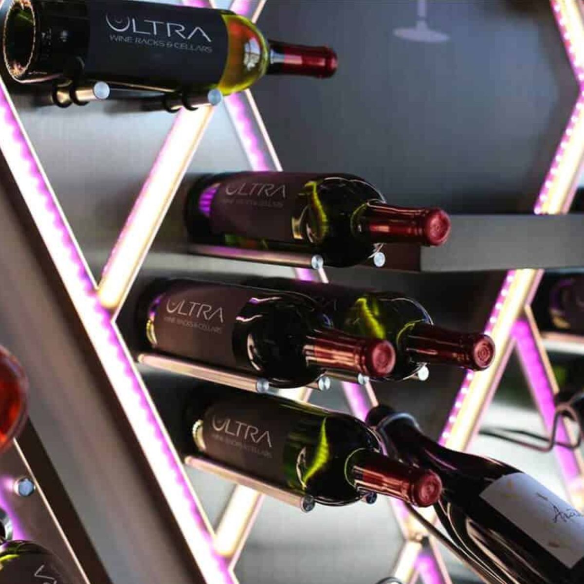 Ultra Cork-Out Straight Wine Peg - Close-up of wine bottles displayed on illuminated racks with purple LED lighting