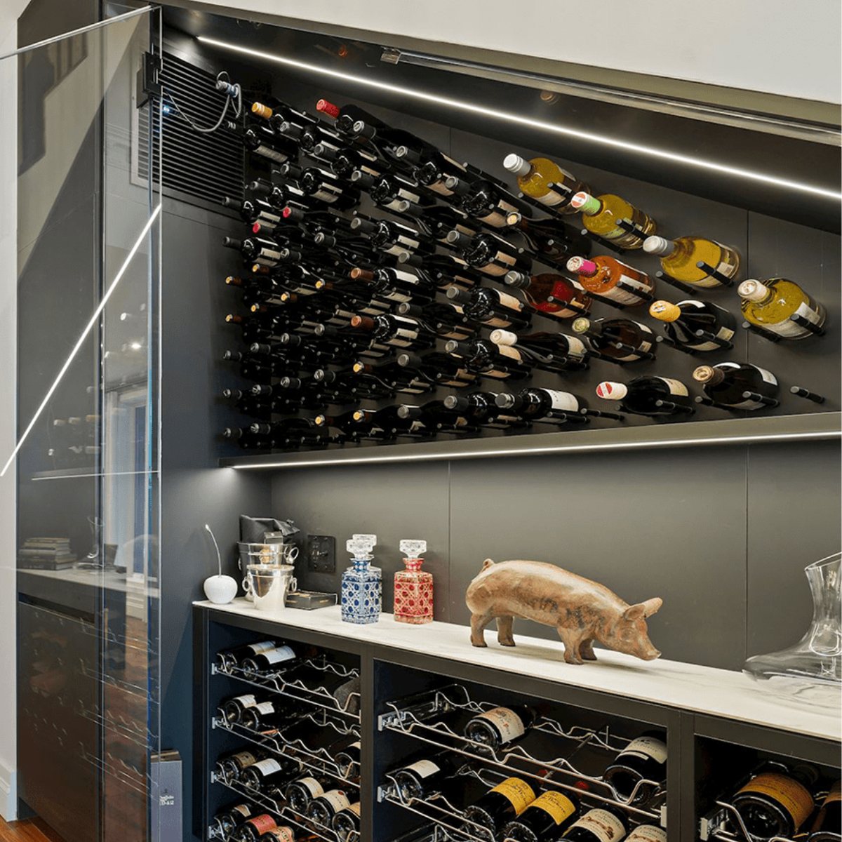 Ultra Cork-Out Straight Wine Peg - Modern wine storage with angled wall-mounted racks, lower cabinets, and decorative display items