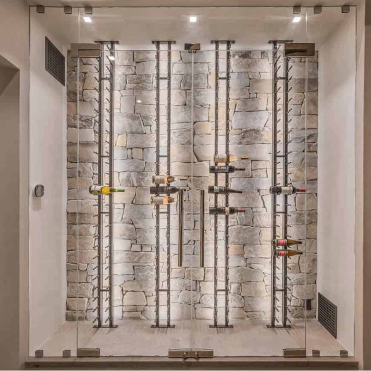 Ultra Floor-to-Ceiling Mounted 1-Sided Wine Rack Display (21 Bottles) - Glass wine cellar with stone wall and vertical bottle racks