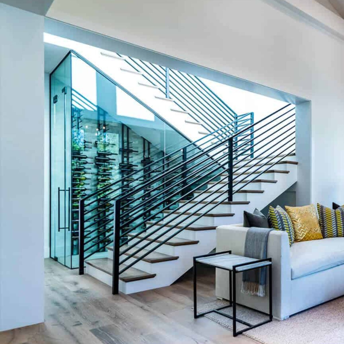 Ultra Floor-to-Ceiling Mounted 1-Sided Wine Rack Display (42 Bottles) - Modern living space with glass wine cellar under staircase
