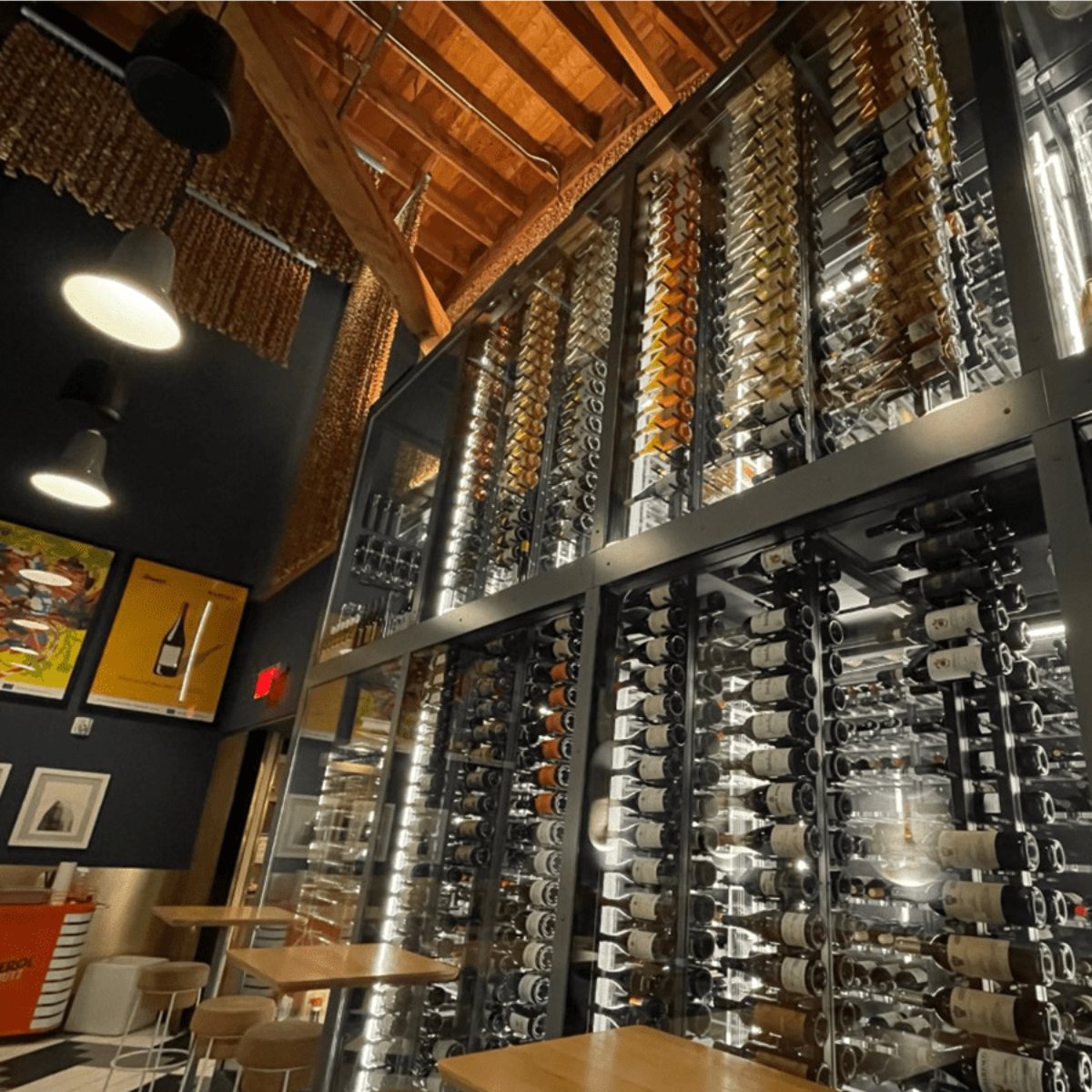 Ultra Floor-to-Ceiling Mounted 2-Sided Wine Rack Display (126 Bottles) - Restaurant wine wall with tall glass racks storing hundreds of bottles in a modern industrial design