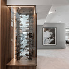 Ultra Floor-to-Ceiling Mounted 2-Sided Wine Rack Display (42 Bottles) - Freestanding glass-enclosed vertical wine display with black metal racking and LED accent lighting