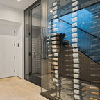 Ultra Floor-to-Ceiling Mounted 2-Sided Wine Rack Display (42 Bottles) - Modern glass wine cellar with wall-mounted racks holding bottles in a label-forward display