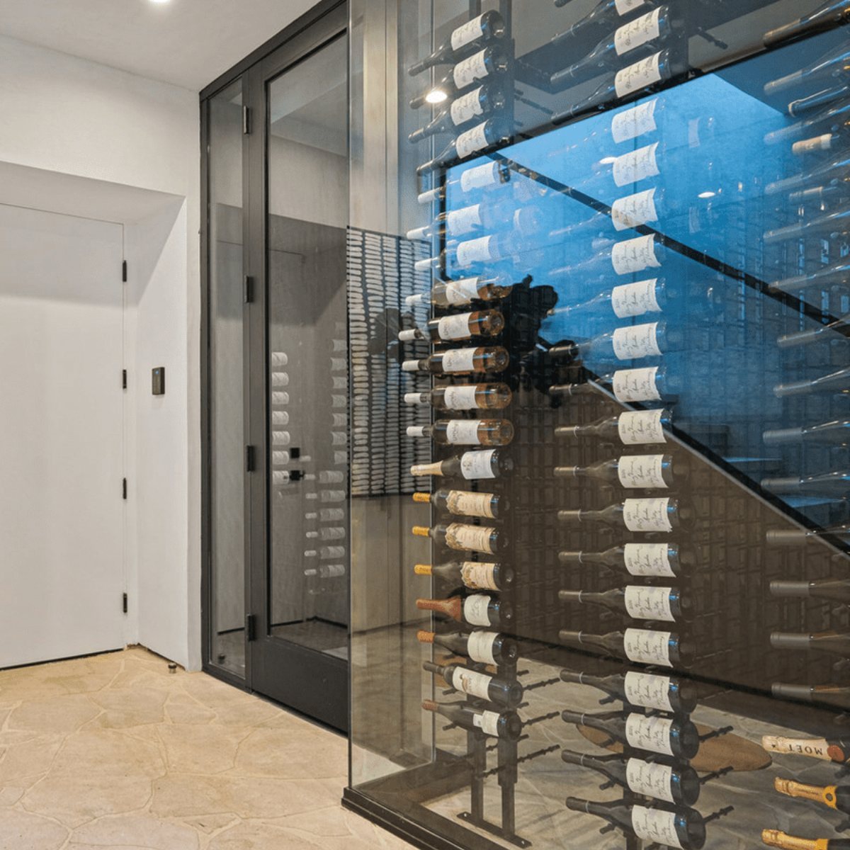 Ultra Floor-to-Ceiling Mounted 2-Sided Wine Rack Display (84 Bottles) - Modern glass wine cellar with wall-mounted racks holding bottles in a label-forward display