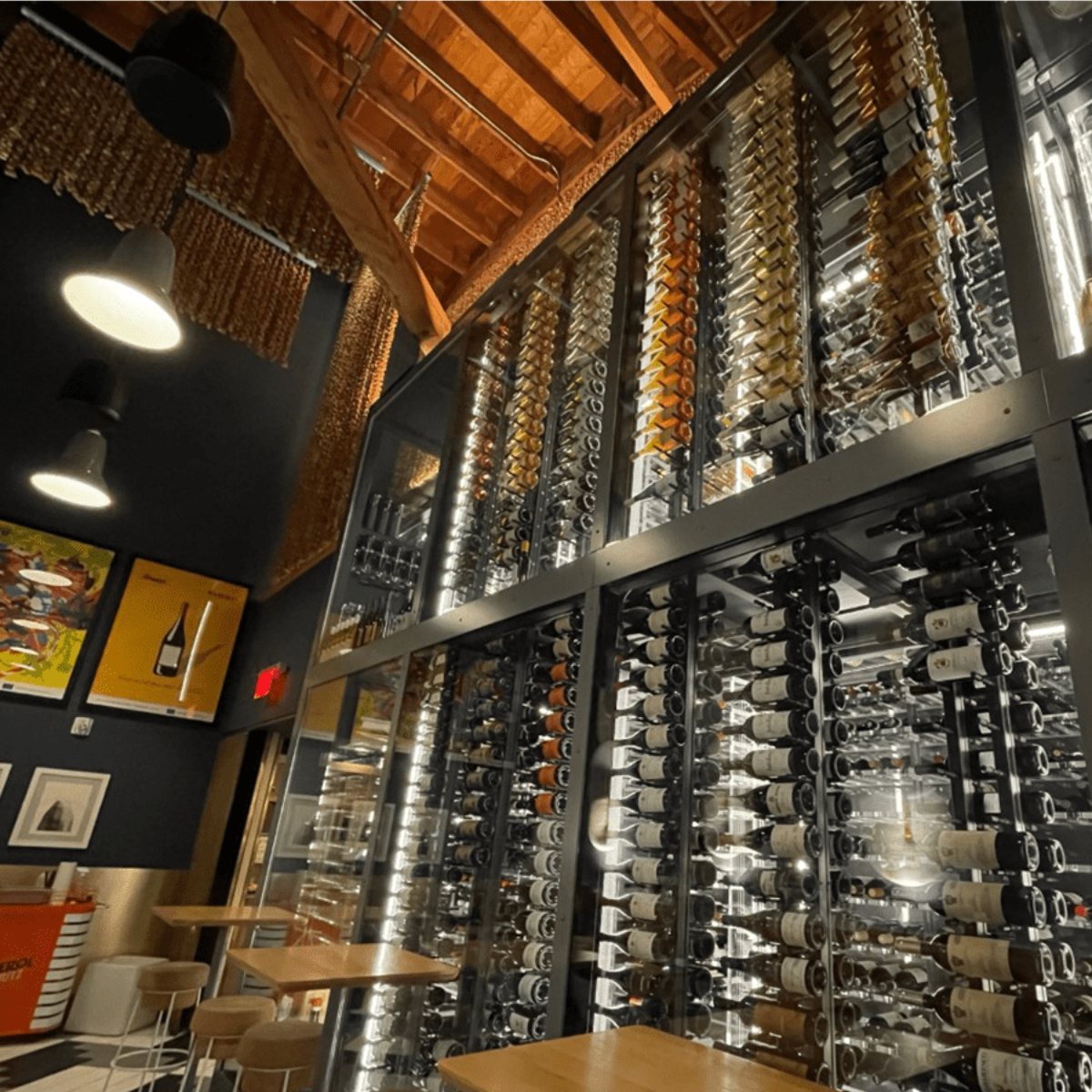 Ultra Floor-to-Ceiling Mounted 2-Sided Wine Rack Display (84 Bottles) - Restaurant wine wall with tall glass racks storing hundreds of bottles in a modern industrial design