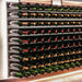 Ultra Fusion 3FT Cork-Out Wine Wall Alumasteel (27 Bottles) - Close-up of wall-mounted wine racks with bottles and LED backlighting