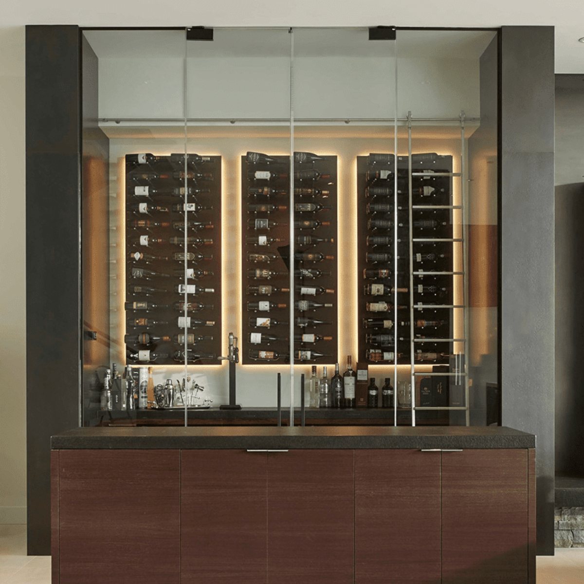 Ultra Fusion 3FT Label Out Wine Wall Black Acrylic (9-27 Bottles) - Glass-enclosed wine display with backlit wall-mounted racks above a modern bar cabinet
