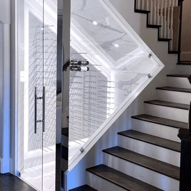 Ultra Fusion 3FT Label Out Wine Wall White Acrylic (9-27 Bottles) - Glass-enclosed wine cellar built under a staircase with wall-mounted racks