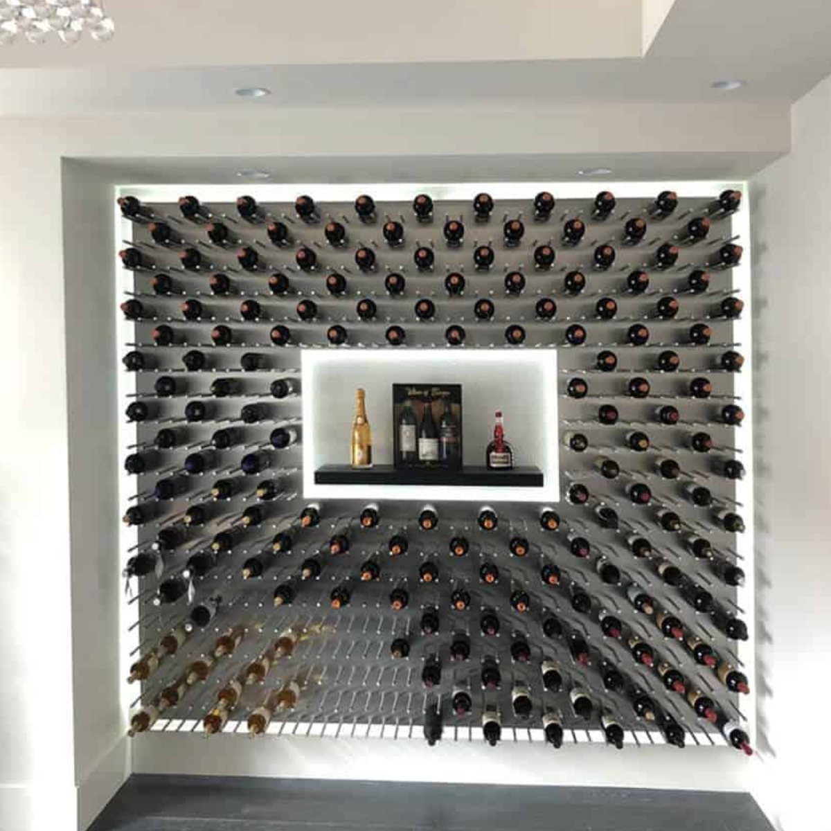 Ultra Fusion Panel Wine Rack – Alumasteel Cork-Out - Backlit wine wall with bottles arranged in a diagonal pattern around a central display shelf