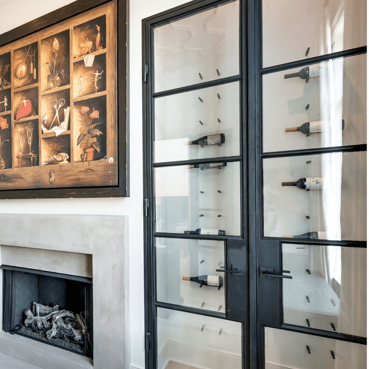 Ultra Fusion Panel Wine Rack – White Acrylic Label-Out - Glass-enclosed wine display with black metal framing beside a modern fireplace and artwork