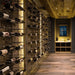 Ultra Label-Out Horizontal Wine Pegs - Rustic wine cellar with wooden ceiling, wall-mounted racks, and warm accent lighting