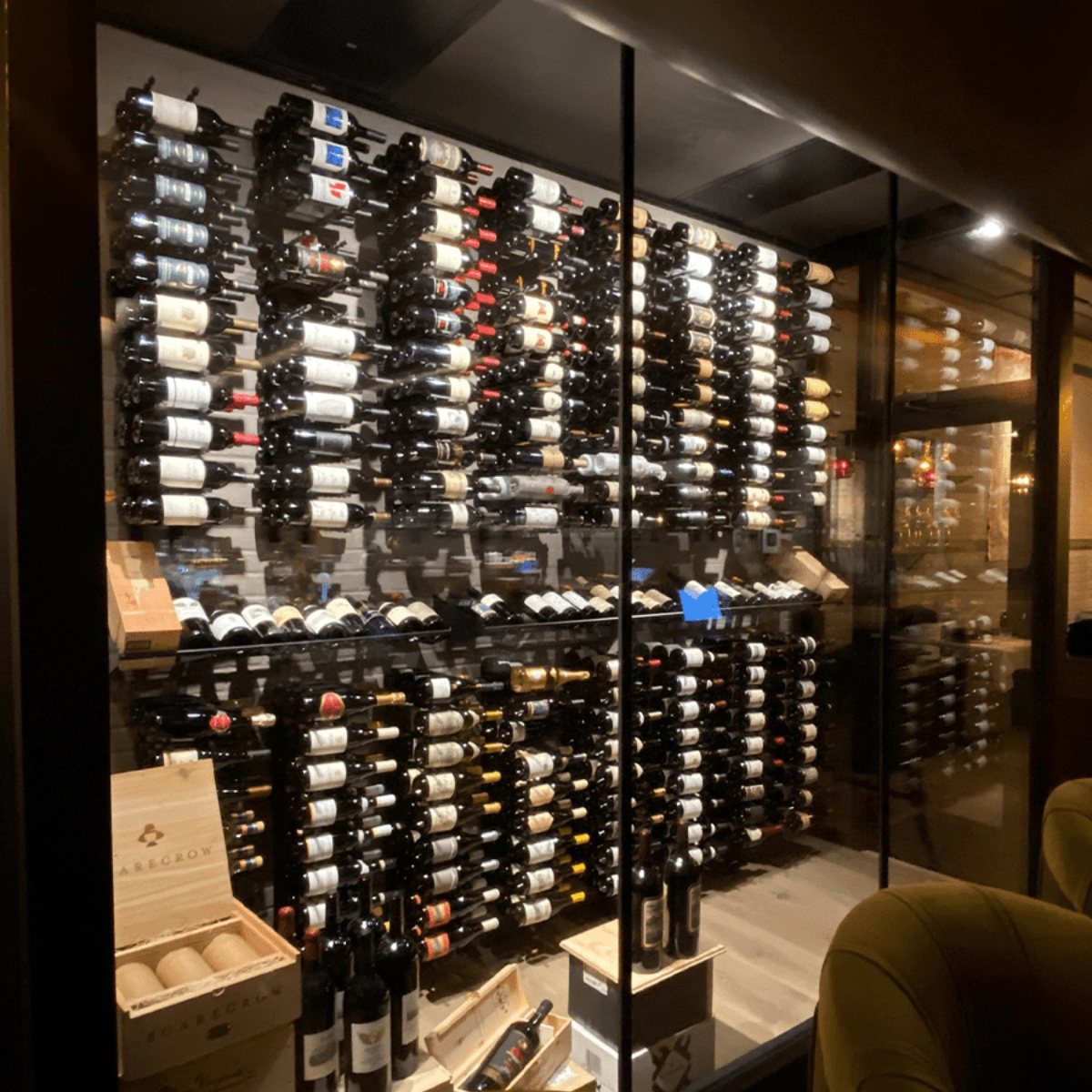 Ultra Showcase Series - Display Row (12 Bottles) - Glass-enclosed wine cellar with wall-mounted racks holding dozens of wine bottles