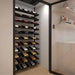 Ultra Showcase Standard Cascade Kits (66 - 99 Bottles) - Modern glass-enclosed wine cellar with black floor-to-ceiling racks holding bottles in a cascading style triple deep