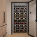 Ultra Showcase Standard Cascade Kits (66 - 99 Bottles) - Modern kitchen with a glass-enclosed wine storage wall featuring multiple rows of bottles