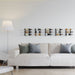 VintageView 1 Foot wall mounted wine rack installed above a sofa on a minimalist white wall with compact bottle storage