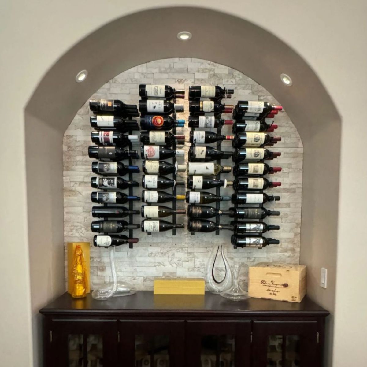 VintageView 3 Foot wall mounted wine rack installed inside an arched wall niche with label forward bottle presentation