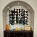 VintageView 3 Foot wall mounted wine rack installed inside an arched wall niche with label forward bottle presentation
