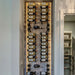 VintageView 3 Foot wall mounted wine rack installed on a backlit wood panel showcasing label forward wine bottle storage