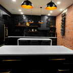 VintageView 4 Foot wall mounted wine rack installed on a brick accent wall in a modern black kitchen with vertical bottle storage