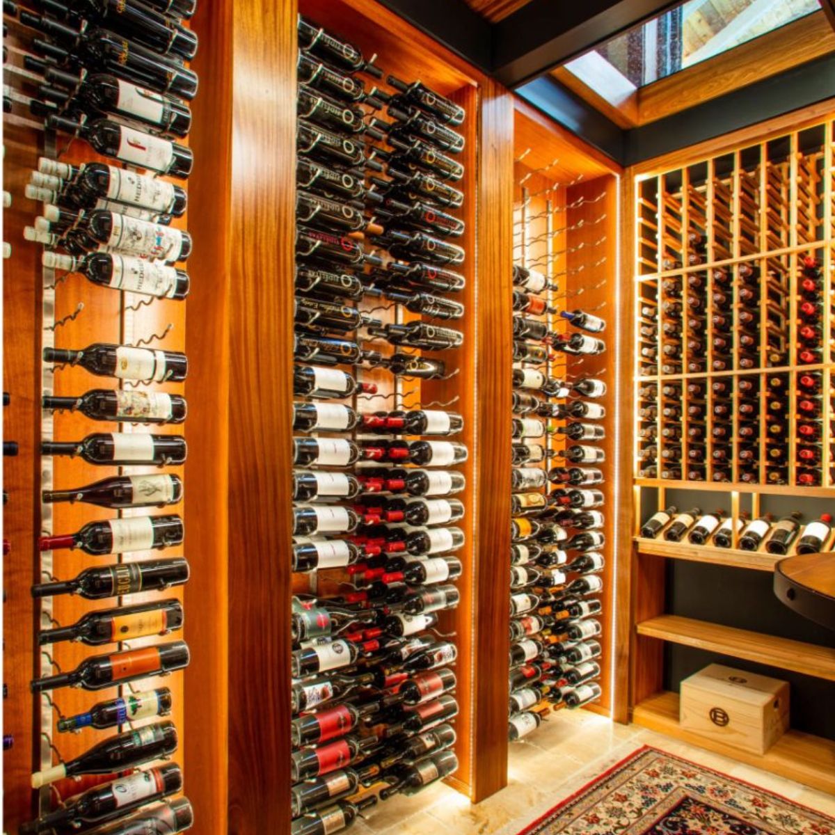 VintageView 4 Foot wall mounted wine storage rack installed in a warm wood wine cellar with label forward bottle display