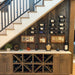 VintageView 4 inch wall mounted metal wine rack installed under a staircase creating a compact residential wine display