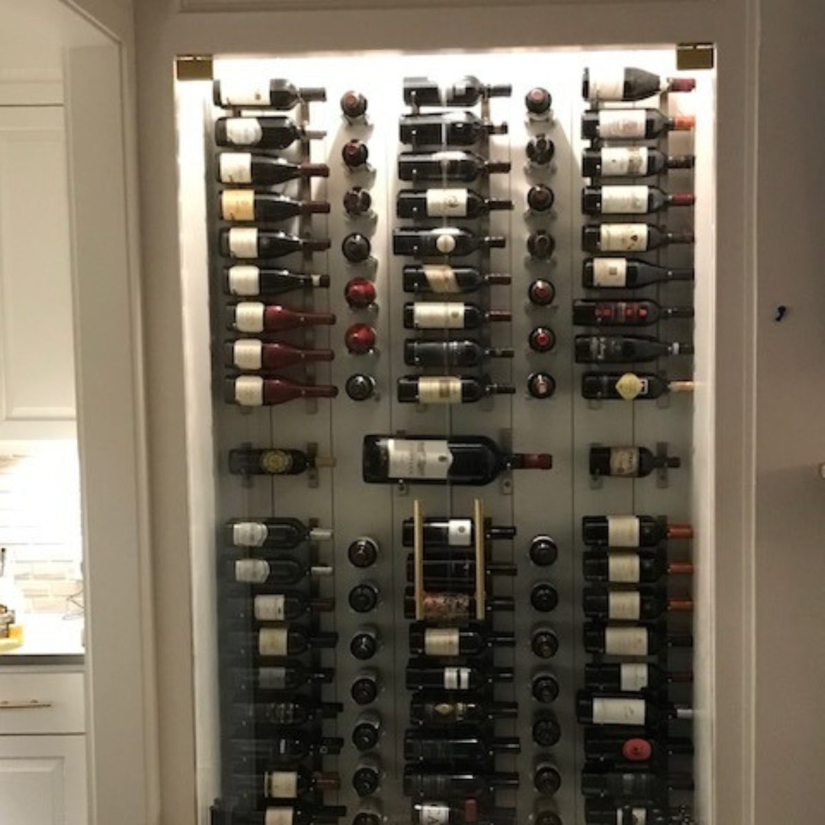 VintageView 4 inch wall mounted metal wine rack installed in a recessed wall niche with label forward wine display