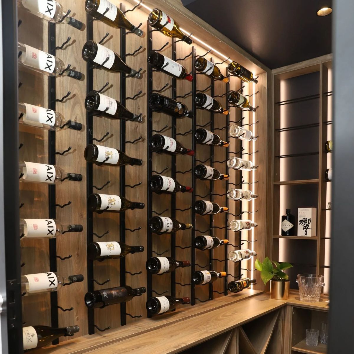 VintageView 5 Foot wall mounted wine rack installed in a modern bar with backlit wood panels and horizontal wine bottle display